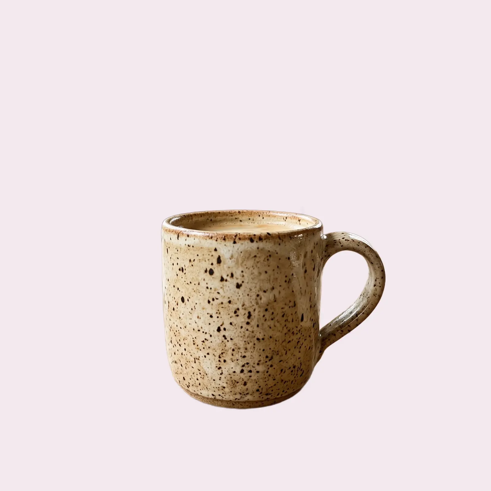 The same handmade mug on a soft pastel background
