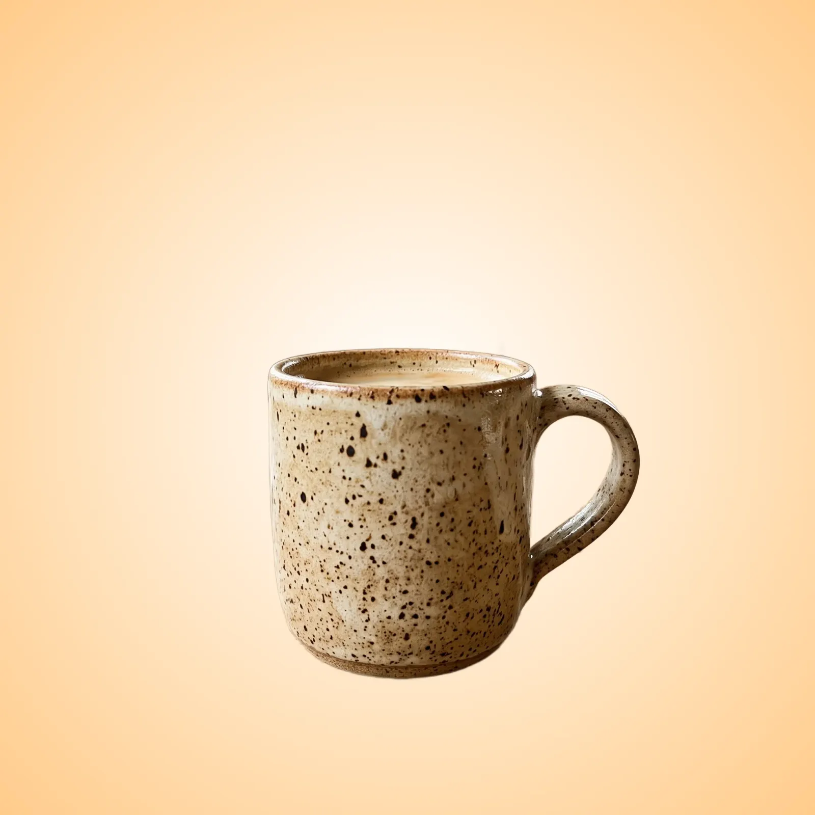 Handmade ceramic mug on a warm cream gradient background